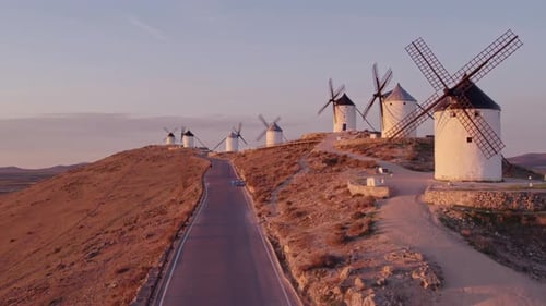 Aerial view of traditional windmills at sunrise with Castillo, Consuegra, Spain.