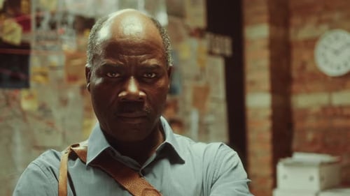 Portrait of Serious African American Investigator at Work in Office