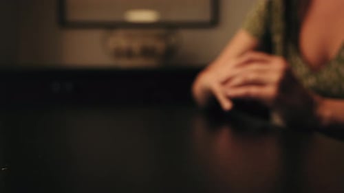 The woman removes the wedding ring from her finger. A feeling of love fading.