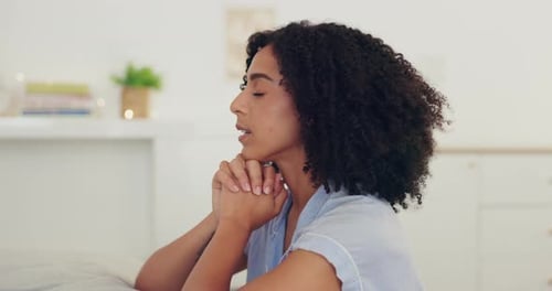 Woman Praying Quietly at Home in Daytime