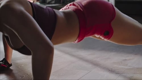 Sexy Young Lady is Exercising on the Floor