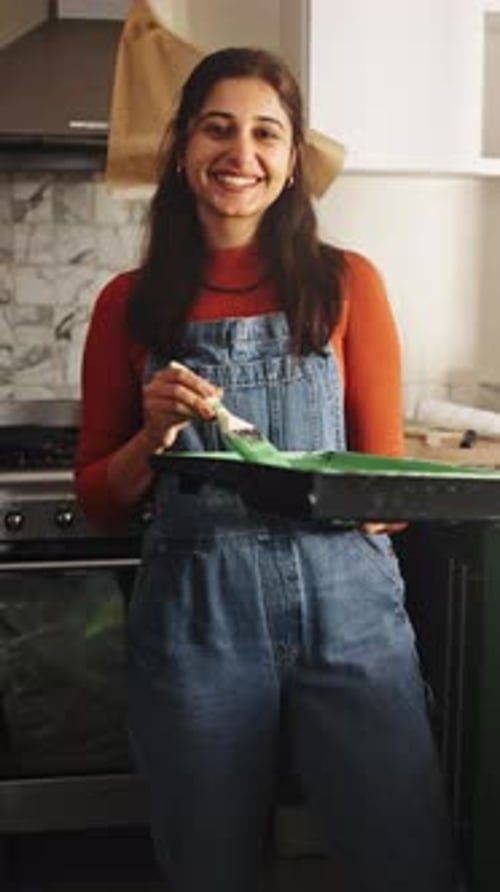 Woman, painting and face with cupboard for kitchen renovations, upgrade and maintenance