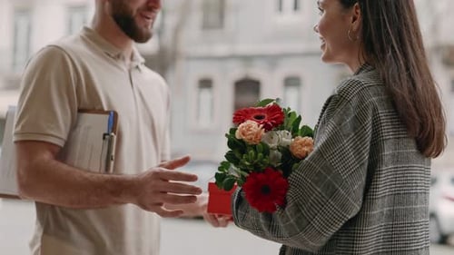 Delivery Man Gives Flowers and Gift to Woman