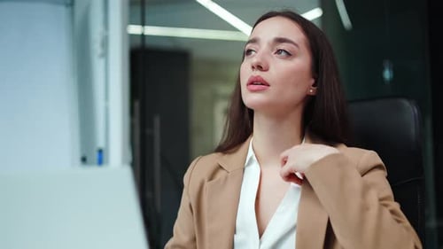 Woman Overheated in Office, Fanning Herself