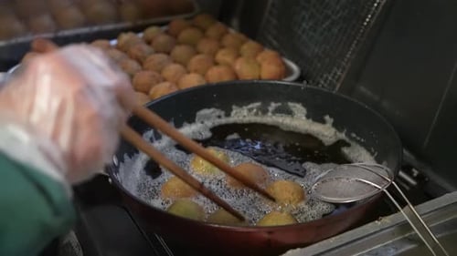 Frying Food Balls in Pan of Boiling Oil