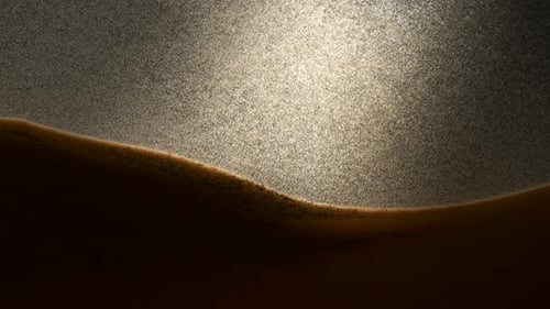 Little grains of sand falling in abstract slow motion