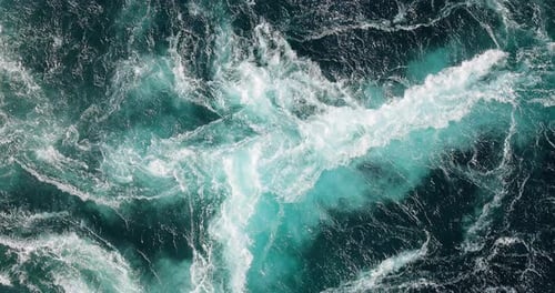 Blue waves of water of the river and the sea meet each other during high tide and low tide.
