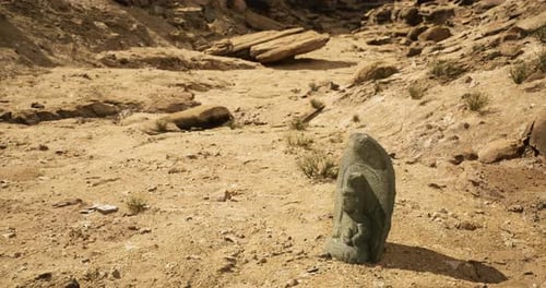 Ancient Stone Carving in a Dry Landscape Highlighting Historical Art