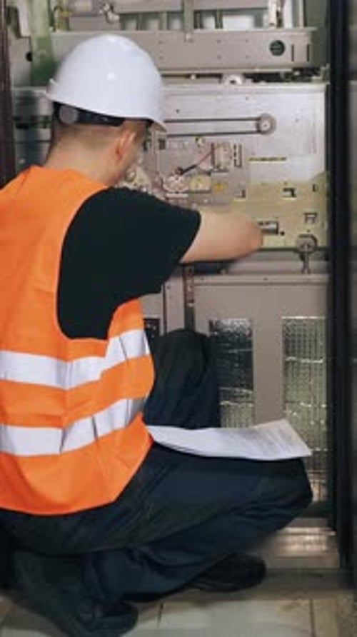 Construction Worker Inspecting Machinery