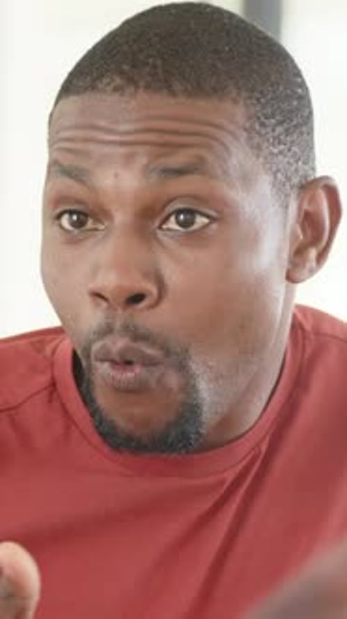 Homme répondant à l'invite de son partenaire dans la scène sociale, signaux animés marquant les gestes du t-shirt rouge hors écran