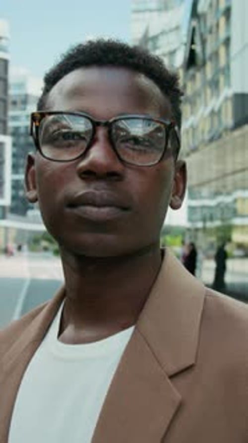 Portrait of Young Manager with Glasses Looking at Camera in Street