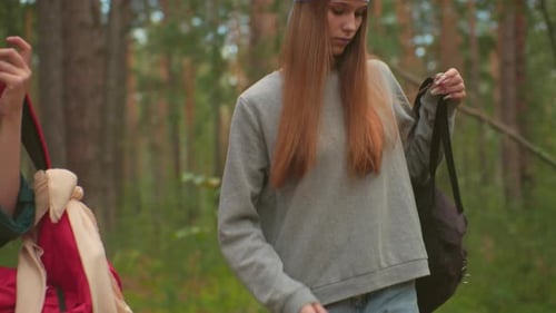 Siblings Hiking Through Serene Forest Preparing for a Rest