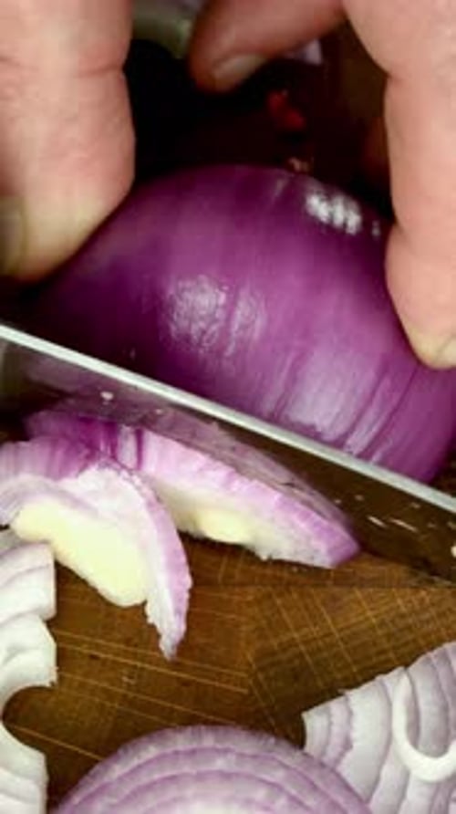 Red Onion Slicing on a Wooden Board