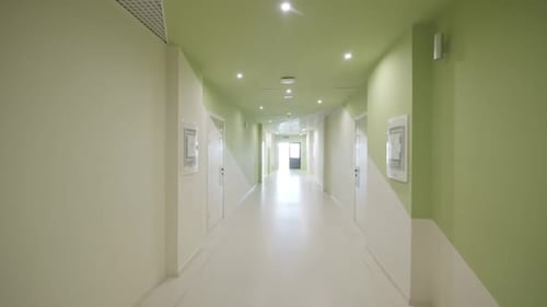 Empty Modern Green and White Hospital Corridor
