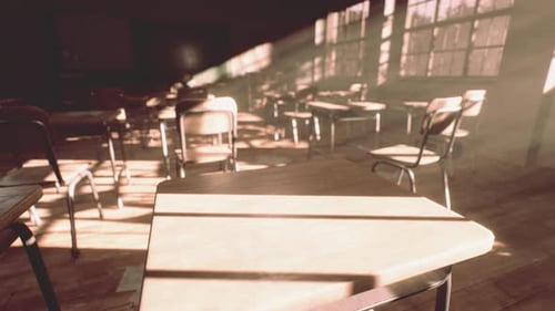 View to Classroom with Tables and Small Blackboard and Grungy Walls