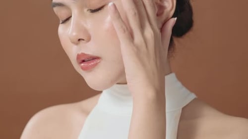 Woman Posing Touching Face In Studio Setting