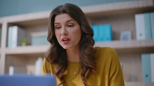 Woman Happily Engages in Video Conference at Home