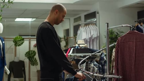 Middle Eastern Customer Explores the Latest Fashion Collection at a Mall Store