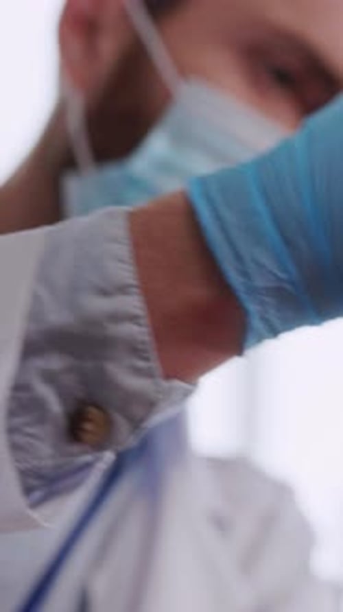 Young Caucasian Doctor Injecting Vaccine for Mature Caucasian Female Patient in Laboratory Center