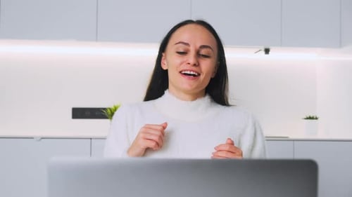 Woman Video Conferencing from Home on Laptop