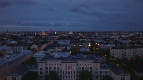 Evening Aerial Footage of City Blocks of Multistorey Town Buildings Along Streets in Urban Borough