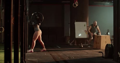 Woman and Man Training in Gym