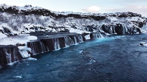 Pure Turquoise Water Glacial River with Huge Current Waterfall in Iceland Frozen Waterfall in Winter