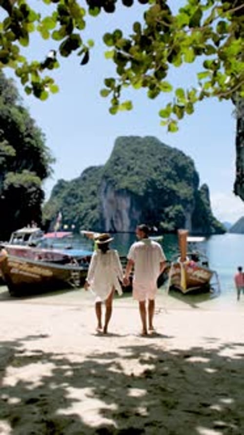 Couple Walking Hand in Hand Along the Sandy Beach in Koh Phi Phi Thailand