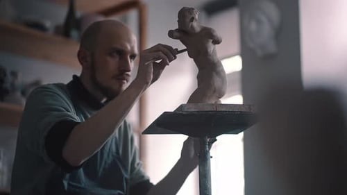 Portrait of a Man Artisan Sculptor Working on New Plaster Figurine in Creative Craft Workshop