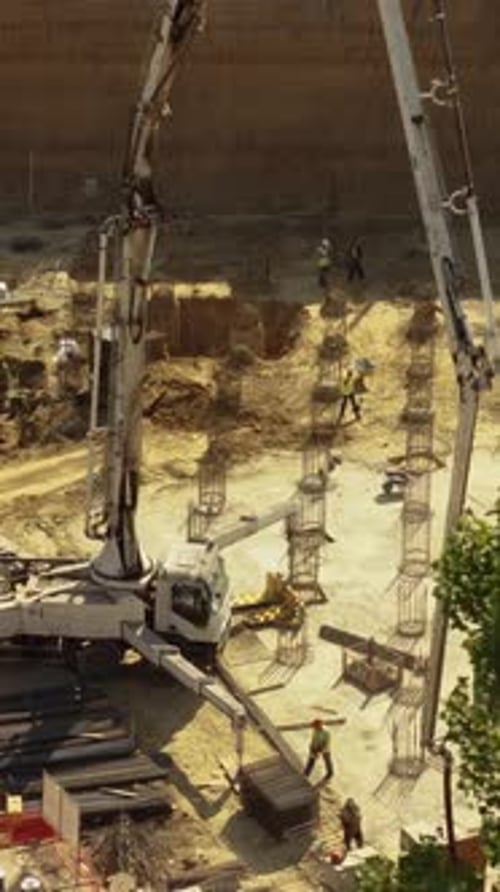 Aerial Vertical View Cement Trucks and Excavation Machinery at Construction Site Editorial