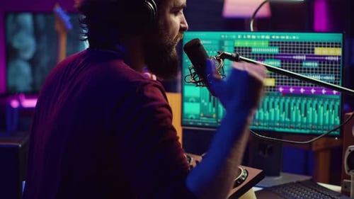 Music Producer Singing at Home Studio Microphone to Record Songs