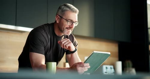 Man Using Tablet in Modern Kitchen Setting