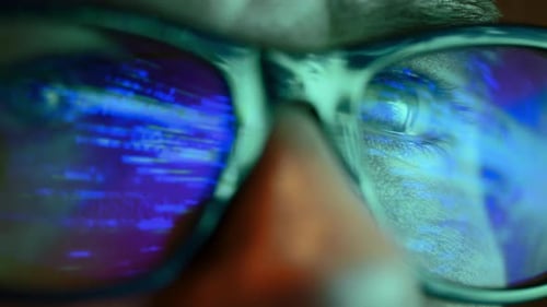 Close Up of Man Eyes Looking Through Glasses at the Flashing Sliding Lights