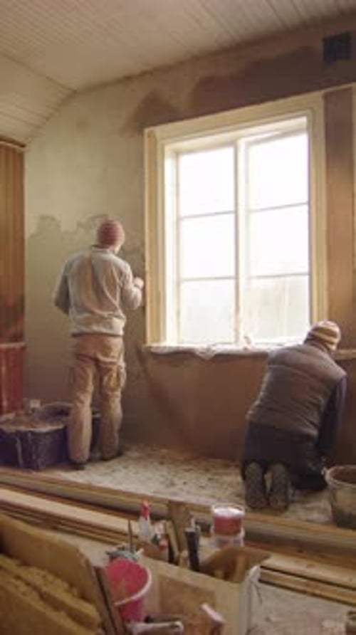 Men Stuccoing Interior Wall in a Home