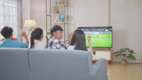 Friends Cheering at Soccer Game in Living Room