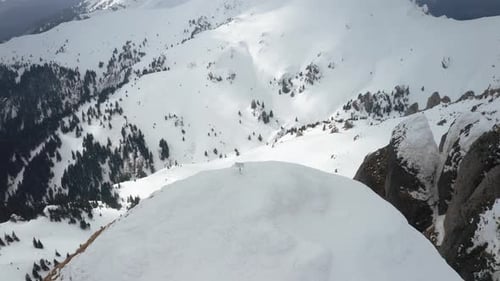 Lone sign atop Tigaile Mari peak with panoramic snowy mountain view, cloudy day