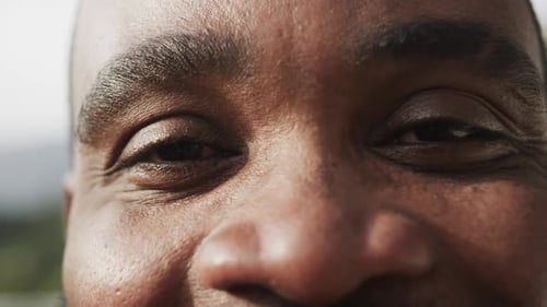 Portrait close up of eyes of happy eyes of african american man, slow motion