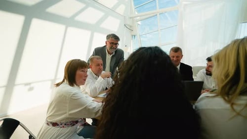 Business Meeting in Modern Office with Team Discussion