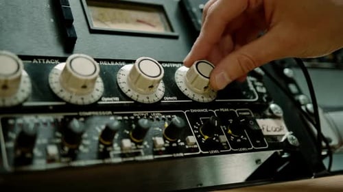 Sound engineer using digital audio mixer sliders Engineer pressing keys adds control panel volume