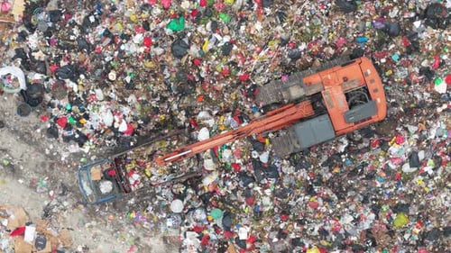 Aerial View of Excavator Moving Waste at Landfill Site