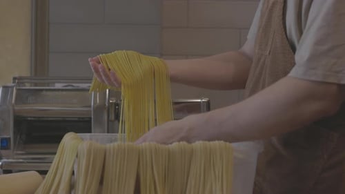 Chef Uses a Pasta Cutting Machine Fresh Homemade Pasta Fresh Handmade Pasta Coming Out From Machine