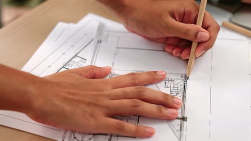 Close up of skilled architect designing blueprint detail on paper. Delineation.