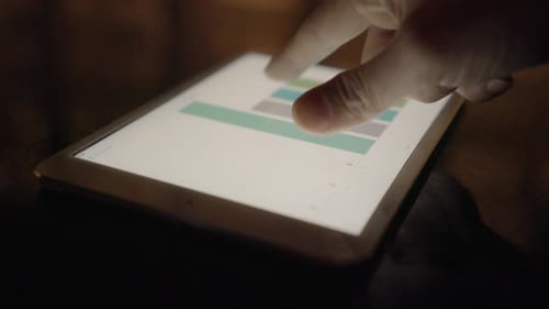 Analyzing Data on Tablet Device at Night