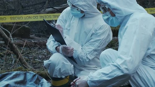 Forensic Specialist Working in the Forest Police Criminalists Collecting Evidence and Making