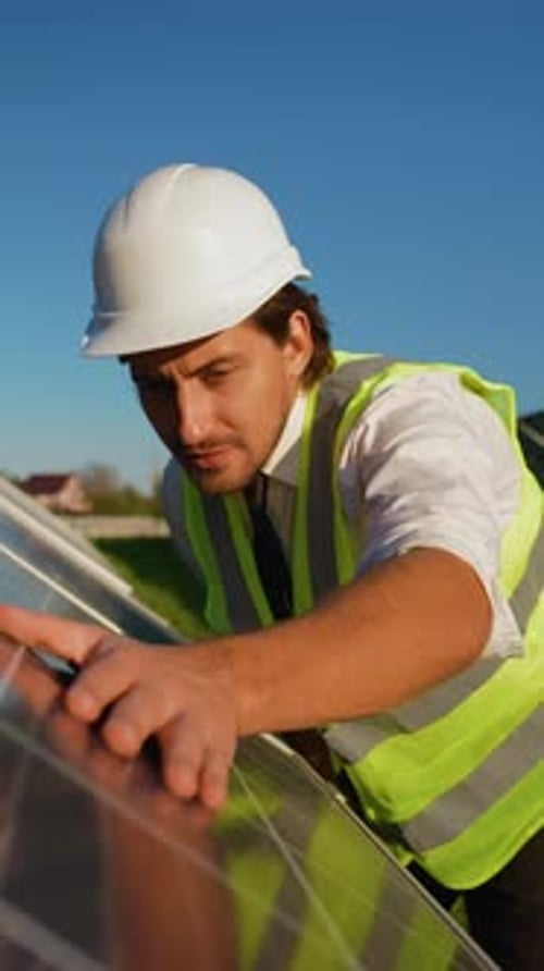 Engineer Conducts Detailed Solar Panel Inspection