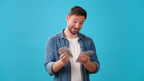 Smiling Bearded Man Counts Money Nodding with Satisfaction