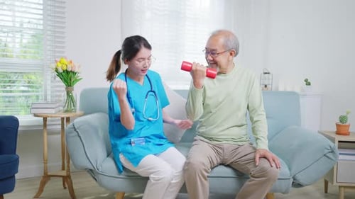 Friendly Physical Therapist Helps Senior Man With Exercise