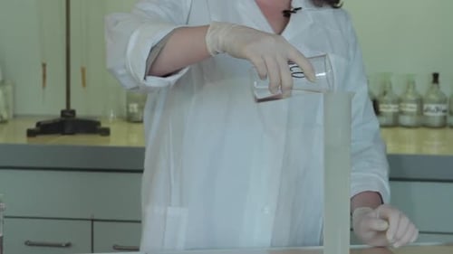 Liquid Being Poured into Graduated Cylinder for Experiment
