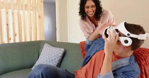 Couple Enjoys Virtual Reality Headset at Home