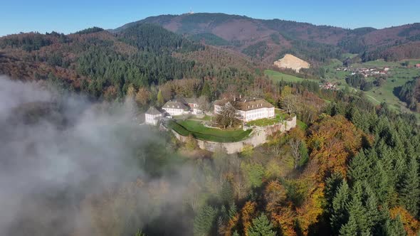 Historic Schloss Bürgeln on a foggy autumn morning in the Black Forest ...